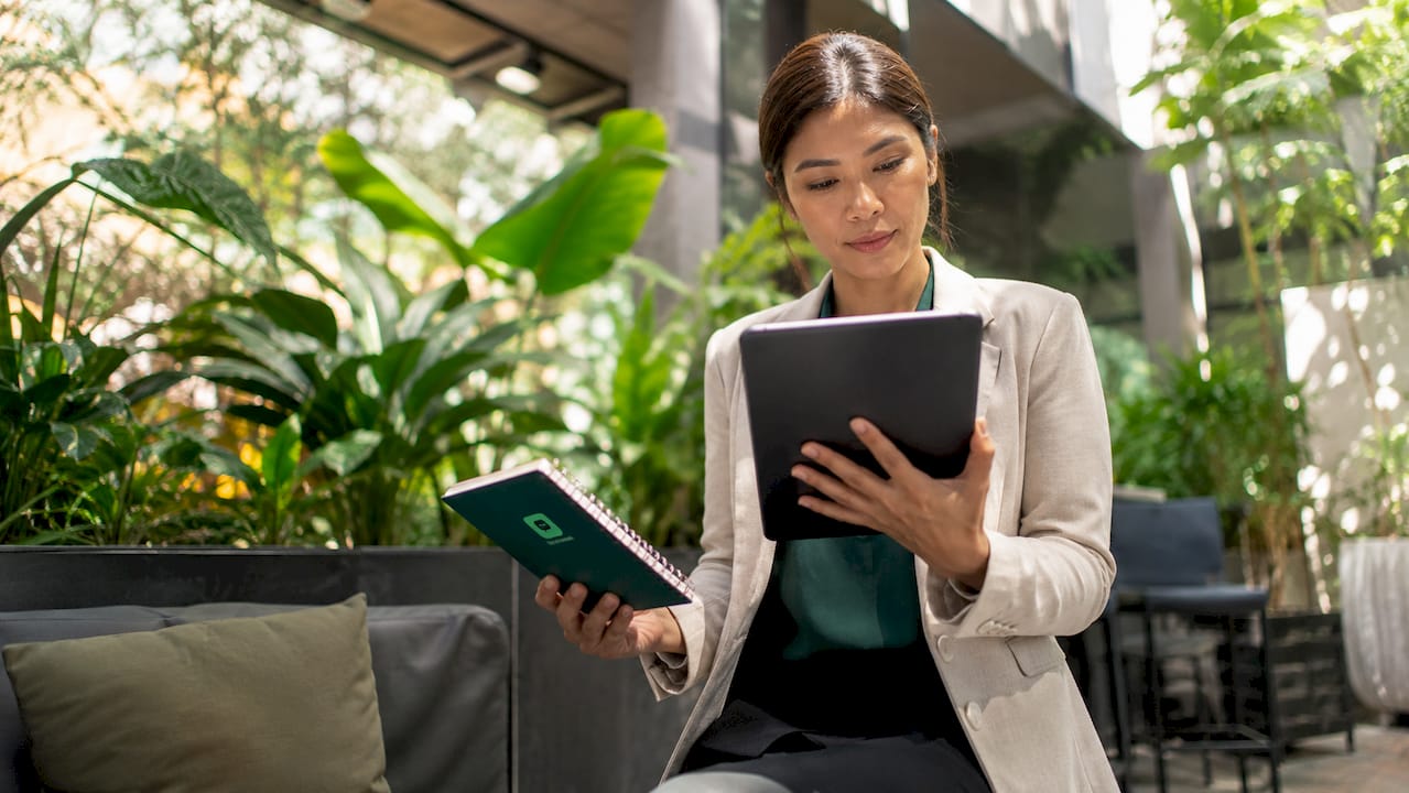 Businesswoman reviewing invoice financing options on tablet