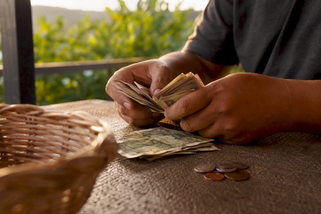 Hands counting cash on table